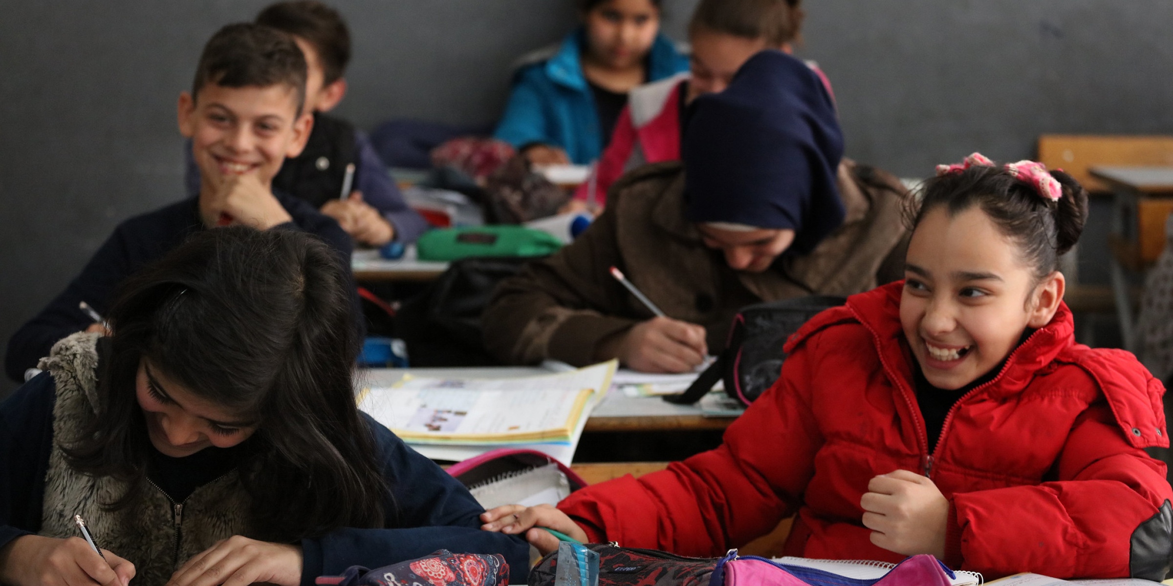 Students at the Second Bourj Hammoud Public School laugh with their teacher while in class, in Beirut, Lebanon.
